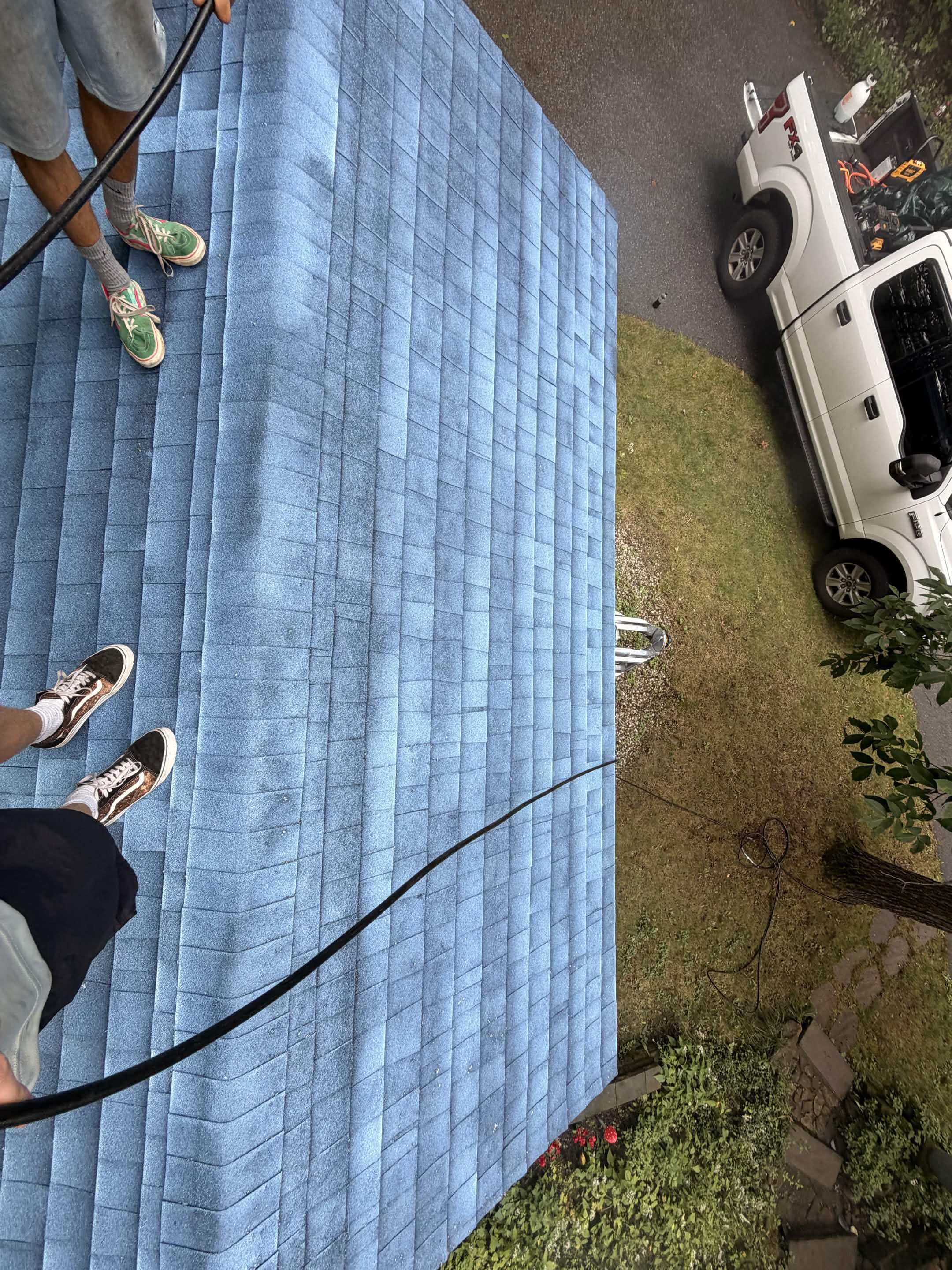 Technicians applying protective roof treatment